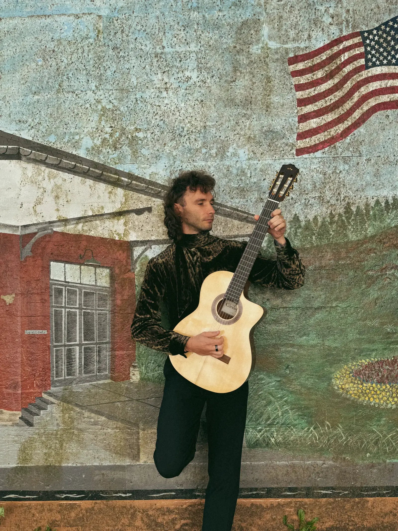 Mathew performing acoustic guitar